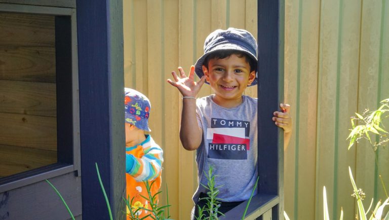 Boy waving his hand.